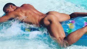 Rearview Naked Hunk Floating in a Pool